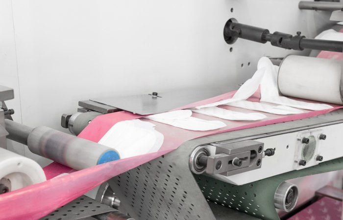 Blyss sanitary pad factory production line with automated machinery in a clean room facility